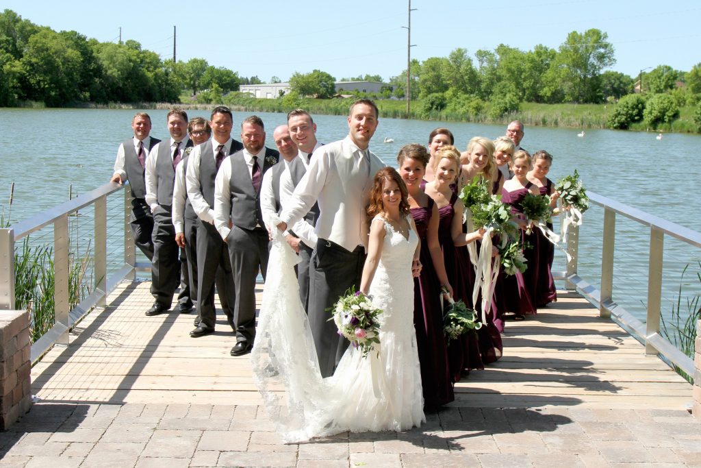 Wedding party on a dock by a lake